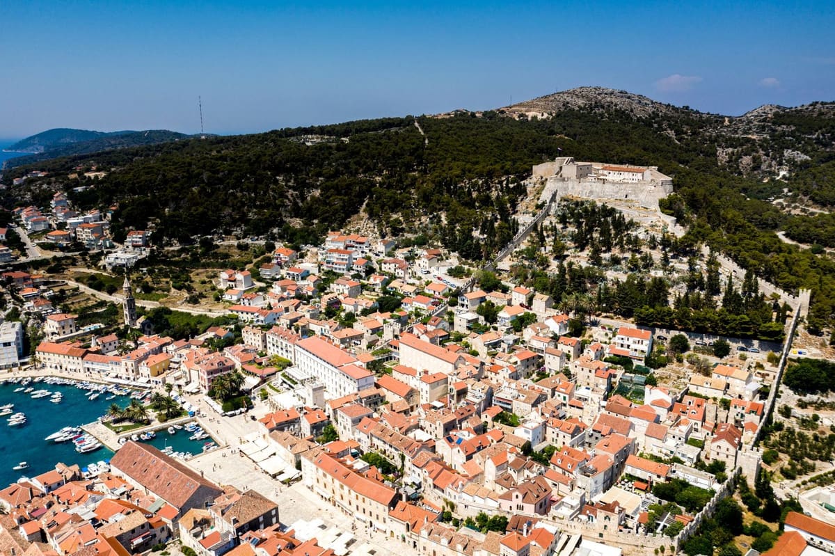 Hvar town from the air, red roofs around the harbour