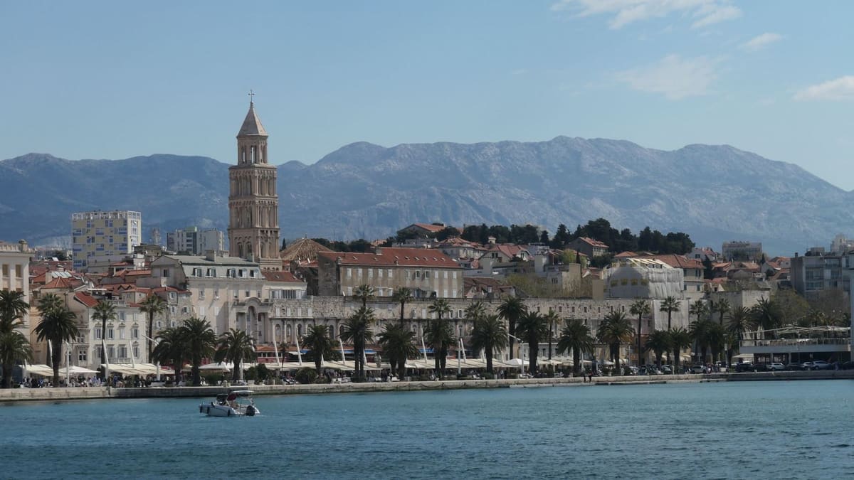 Split from the sea, the cathedral bell tower against the mountains